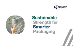 Hand holding a roll of stretch film with a green leaf, symbolizing eco-friendly packaging by Whitworth Engineers